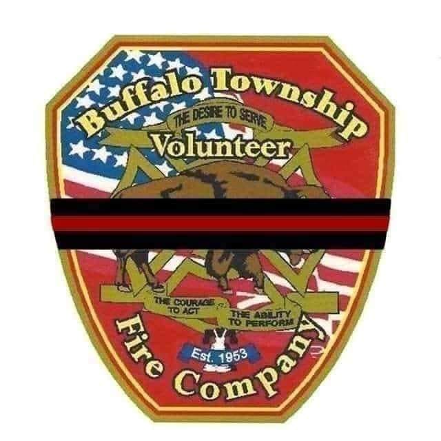 A badge for the Buffalo Township Volunteer Fire Company, established in 1953, featuring an American flag background and a buffalo in the center. It includes the phrases "The Desire to Serve," "The Courage to Act," and "The Ability to Perform," with a black mourning band across it.